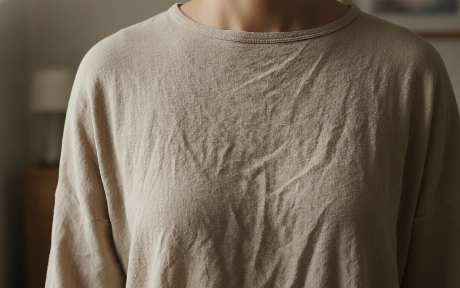 Cotton wrinkles at the elbow. The weave is visible, so the shirt does not look molded from plastic.